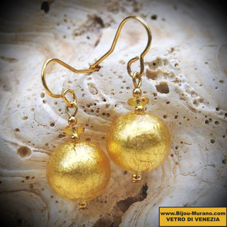 Gold earrings in real glass of murano in venice, ball gold of venice