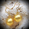 Gold earrings in real glass of murano in venice, ball gold of venice